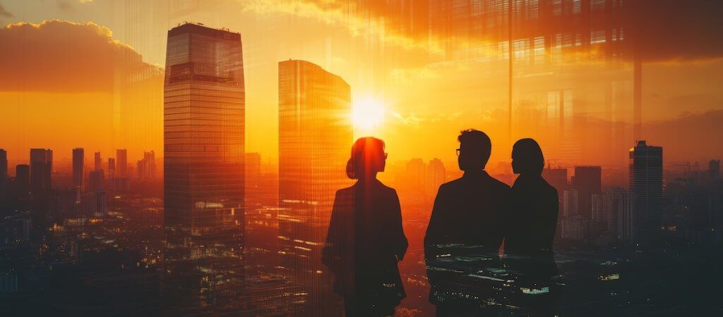 Business People Silhouettes Overlooking Sunset Cityscape